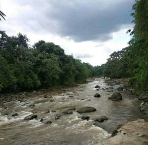 View of stream flowing through rocks