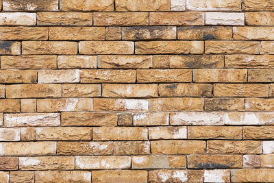 Background of modern yellow brick wall texture, abstract stone surface