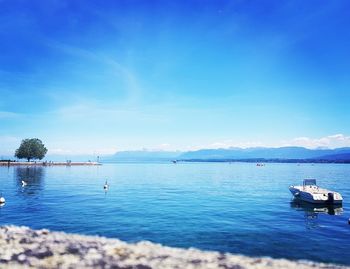 Scenic view of sea against blue sky