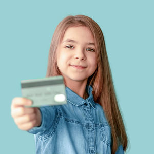 Young woman using mobile phone against blue background
