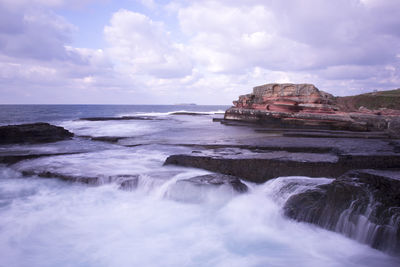 Scenic view of sea against cloudy sky