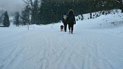 Couple on snow covered landscape