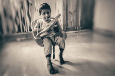 Portrait of boy holding while sitting