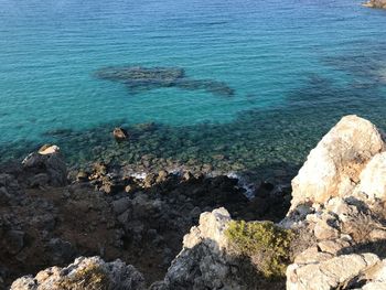 High angle view of rocks by sea