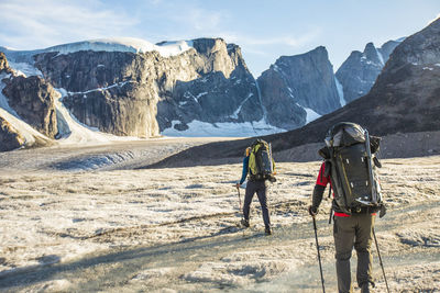 Rear view of two mountaineers exploring auyuittuq national park