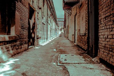 Empty alley amidst buildings in city