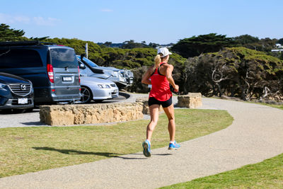 Full length of woman walking on road