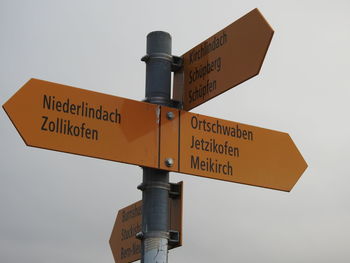 Low angle view of road sign against sky