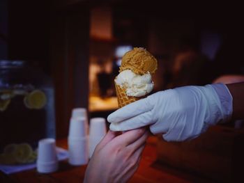 Close-up of hand holding ice cream cone