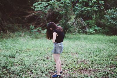 Full length of woman standing on grass