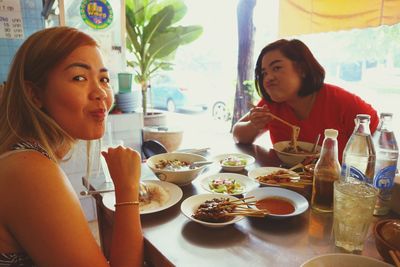 Portrait of young women sitting at restaurant table