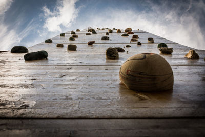 Stack of stones on table against sky