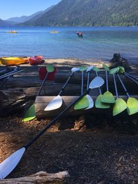 Boats moored on lake against mountains