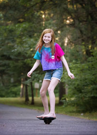 Pre teen red haired girl ripsticking