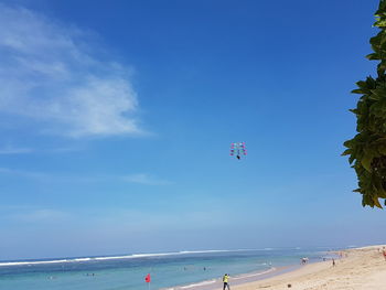 Scenic view of sea against blue sky on sunny day