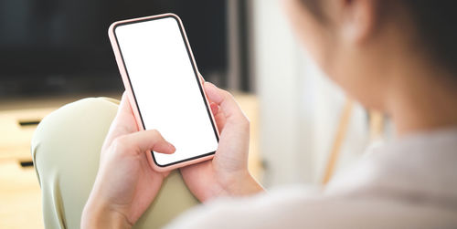 Midsection of woman holding smart phone