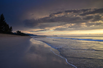 View of beach against cloudy sky