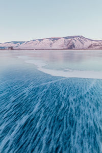 Scenic view of frozen lake against clear sky