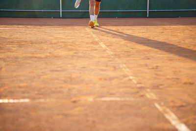 Low section of man skateboarding on floor