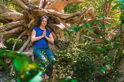 Portrait of smiling young woman against plants