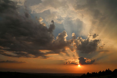 Scenic view of dramatic sky over sea during sunset