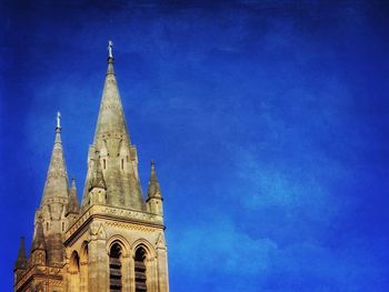 Low angle view of church against blue sky