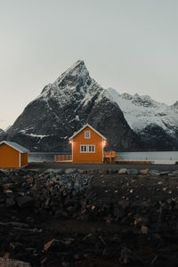 House by mountain against sky