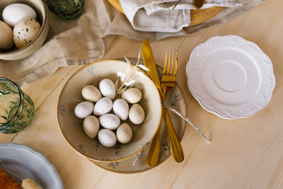 Easter table setting with eggs in a plate. serving a festive breakfast or lunch. flat lay