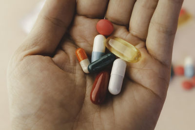 Close up woman taking vitamins and supplements in hand. medicines concept.