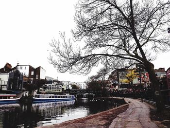 Canal amidst buildings against sky in city