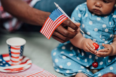 Midsection of couple holding flag