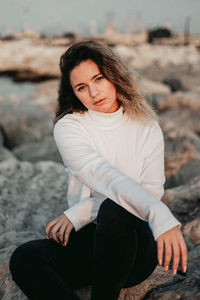 Portrait of young woman sitting outdoors