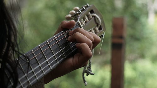 Close-up of man playing guitar