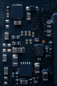 Electronic chip component on black pcb or printed circuit board with dust