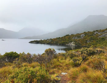 Scenic view of lake and mountains against sky