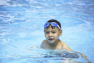 Portrait of boy swimming in pool