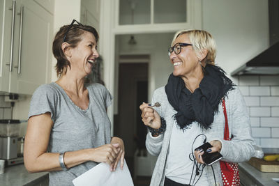 Happy industrial designers discussing at domestic kitchen