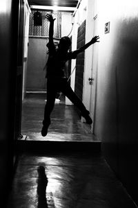 Full length of man jumping in corridor