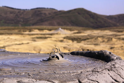 Motorcycle on desert against sky