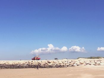 Scenic view of desert against blue sky