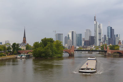 Boat in river with buildings in background