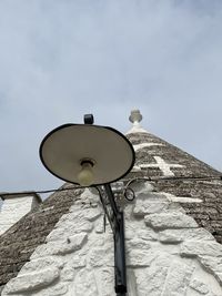 Low angle view of street light against building