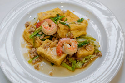 Directly above shot of noodles with meat in plate on table