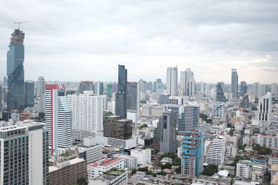 Cityscape against cloudy sky