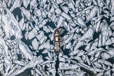 Aerial view of ship amidst glacier in sea