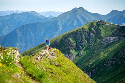 Man standing on mountain against sky