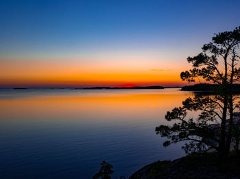 Scenic view of sea against romantic sky at sunset