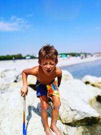 Portrait of boy playing at beach