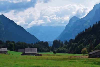 Scenic view of field and mountains against sky