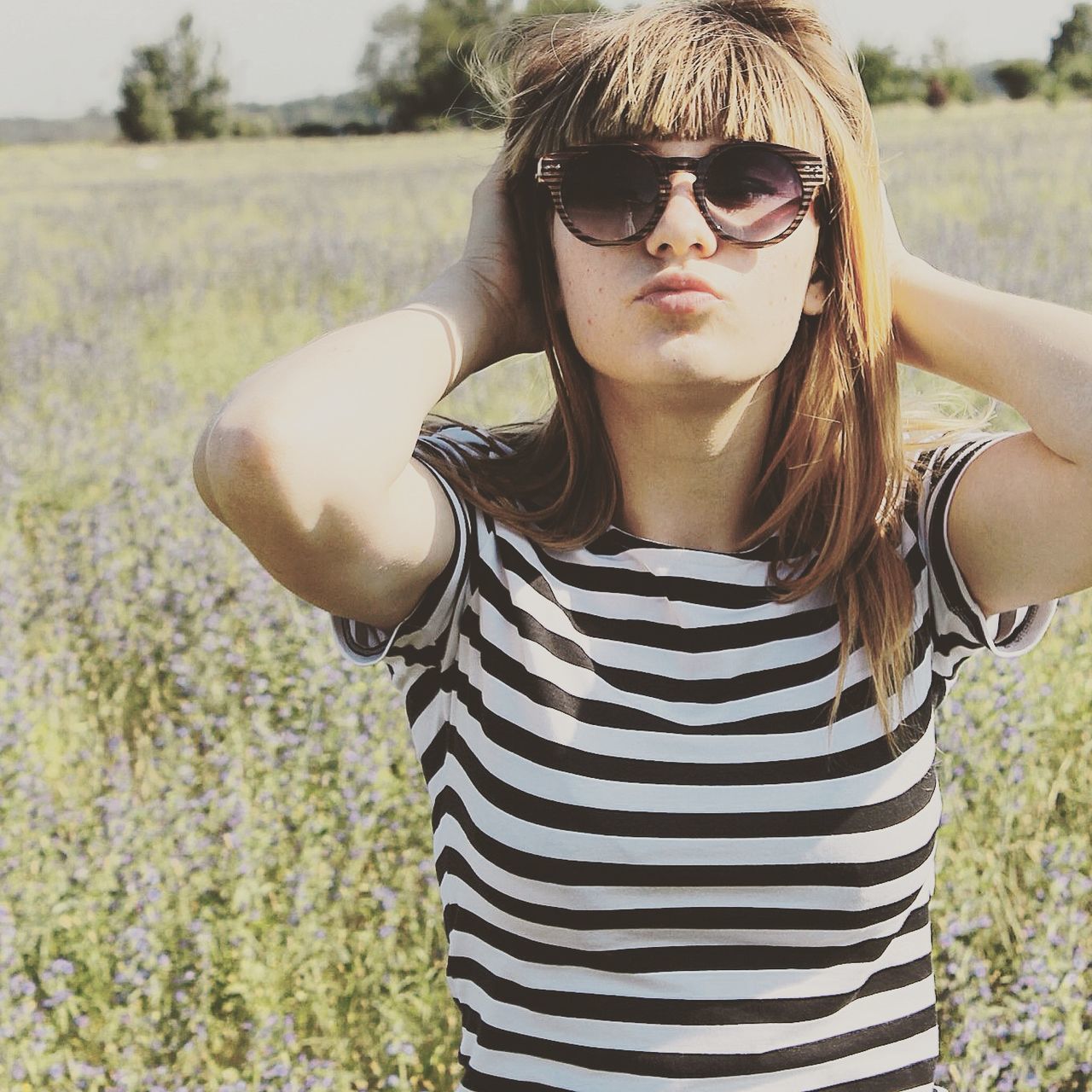 young adult, lifestyles, focus on foreground, portrait, person, leisure activity, looking at camera, sunglasses, front view, casual clothing, young women, smiling, grass, field, day, outdoors, standing